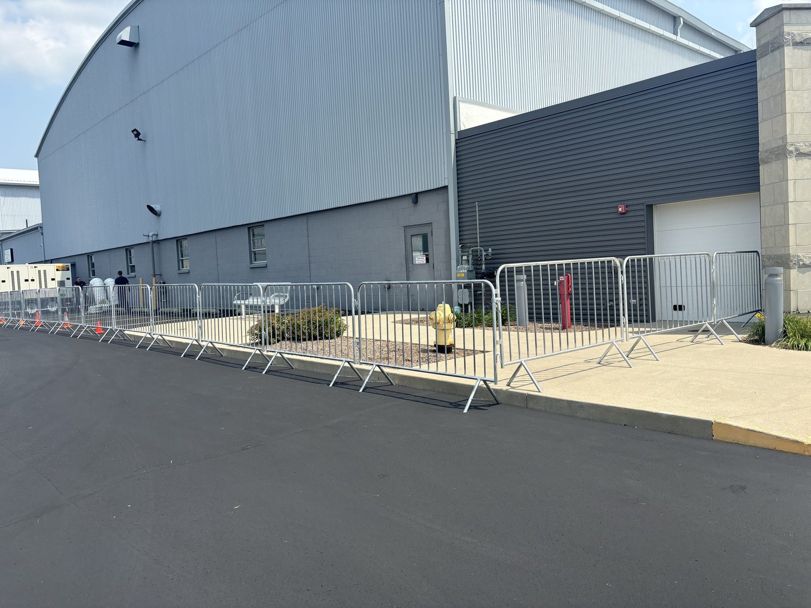 Crowd-control barricades lining a venue building