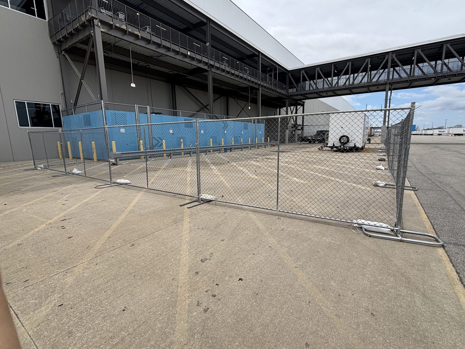 Panel fence across a loading area