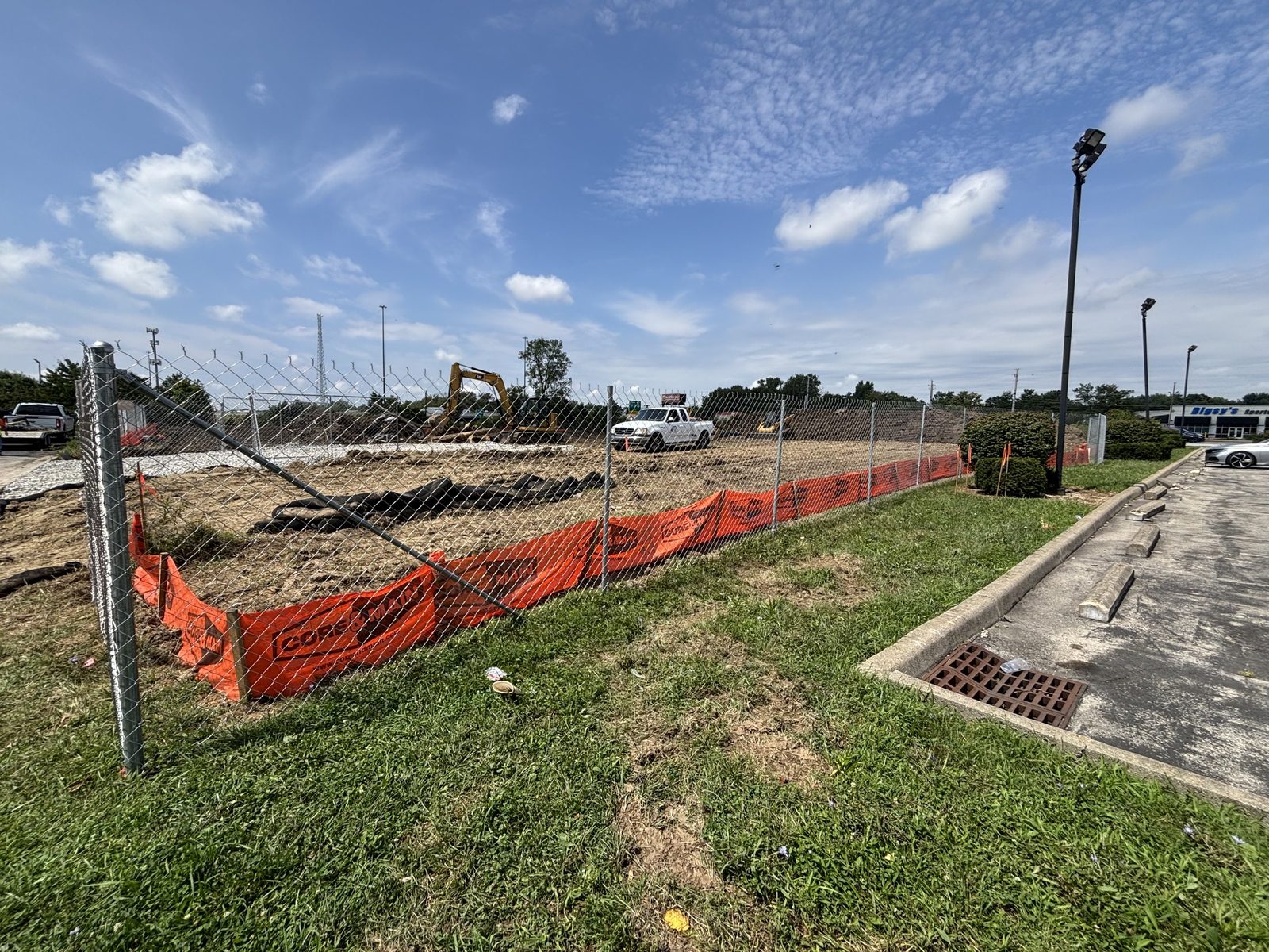 Fence run with orange safety mesh