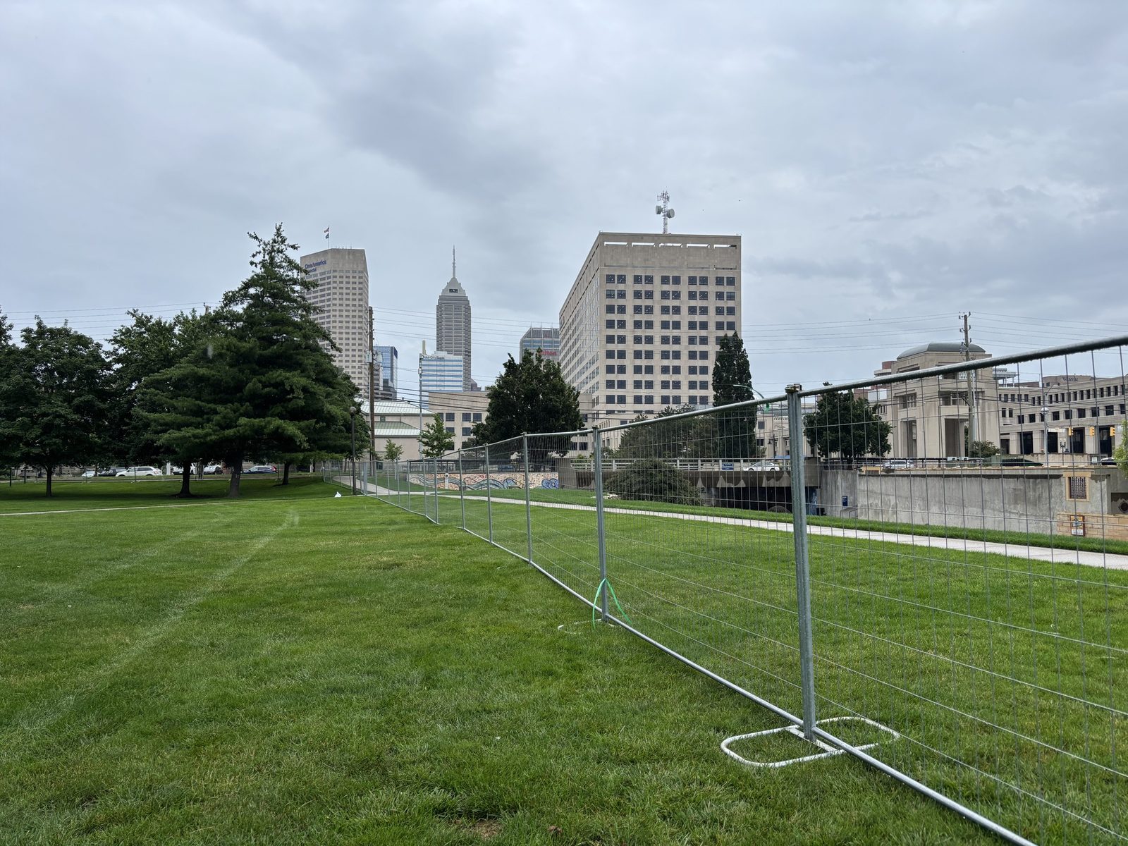 Temporary fence panels with the Indianapolis skyline behind