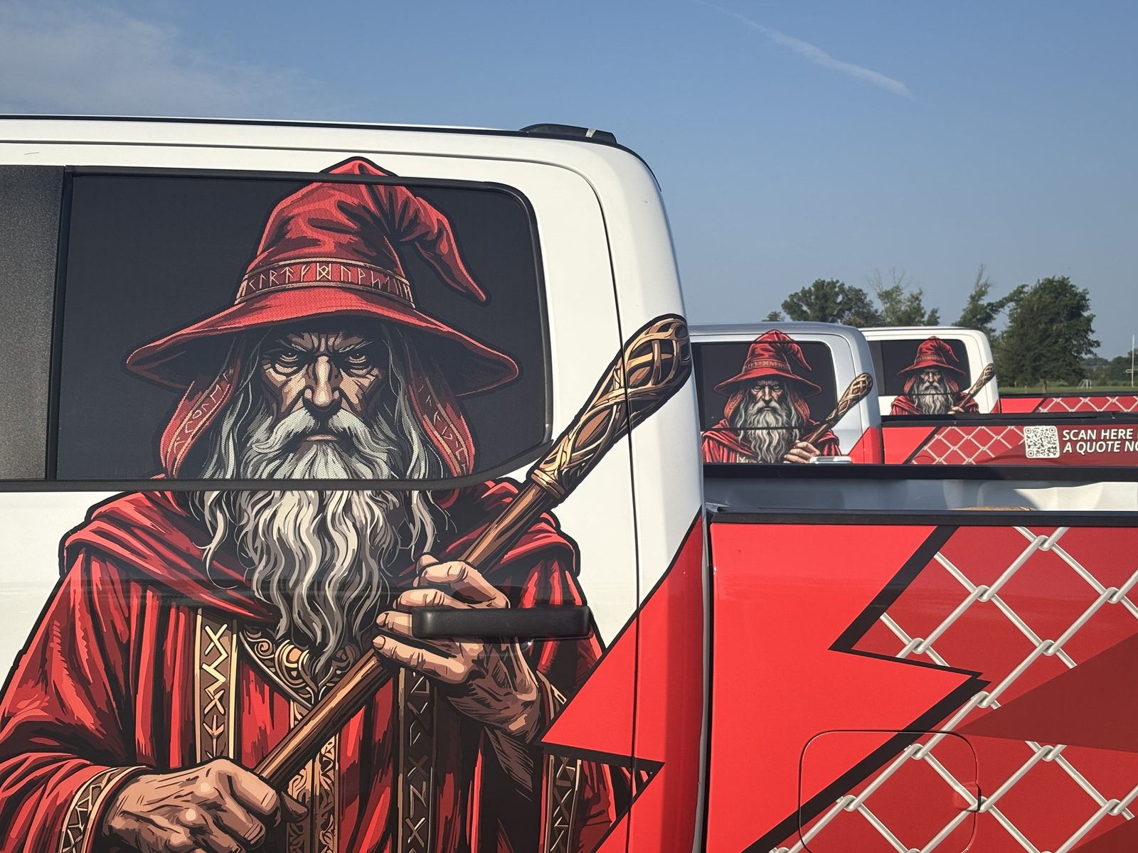 A wrapped Fence Wizards truck with the wizard artwork